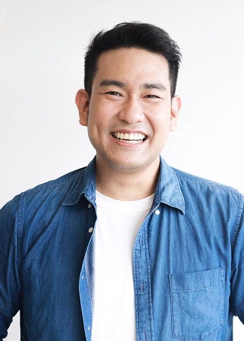 Smiling asian man in blue shirt